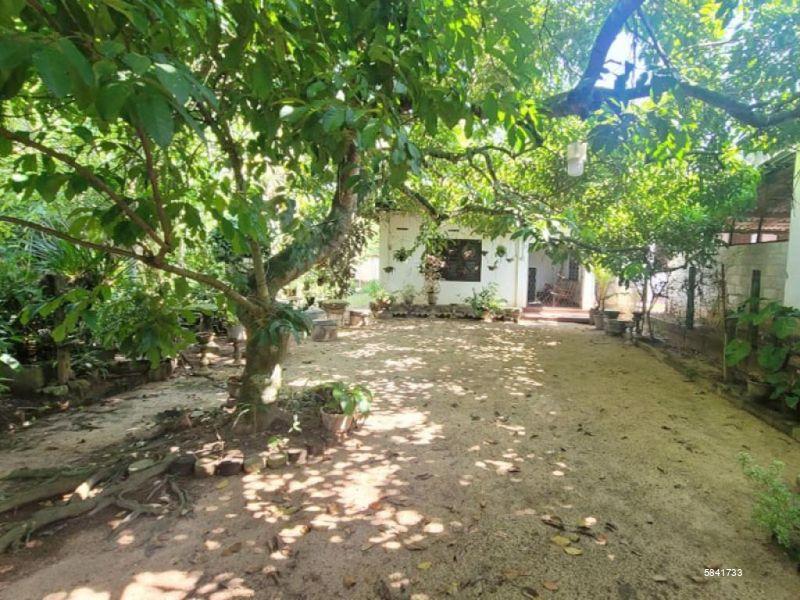 Land with house for sale in Udugampola