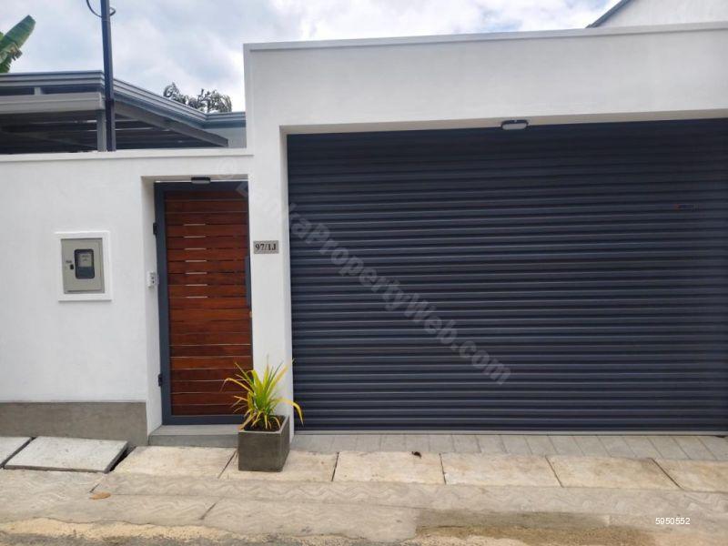 Exterior - Roller agte and wicket gate wih utility meters facing road - House for sale in Dampe